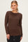 woman wearing a brown long sleeve top with a classic round neckline and a relaxed fit