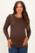 woman wearing a brown long sleeve maternity top and posing with a subtle baby bump