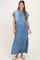woman wearing a light wash denim maxi shirt dress with rolled sleeves and side slits, showcasing her baby bump
