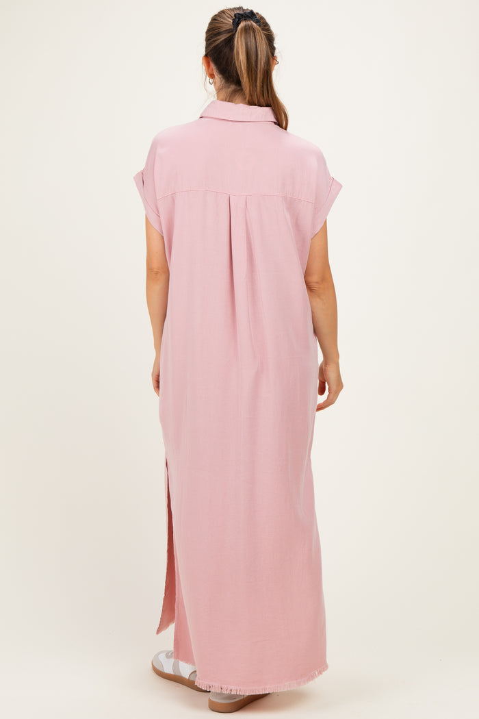 woman wearing a pink maxi maternity dress with short sleeves and a back pleat, showing a relaxed fit