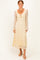 woman wearing a beige floral lace maxi dress with long sleeves and a tie front detail