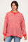 woman wearing a red and white striped oversized sweatshirt with a relaxed fit and long sleeves