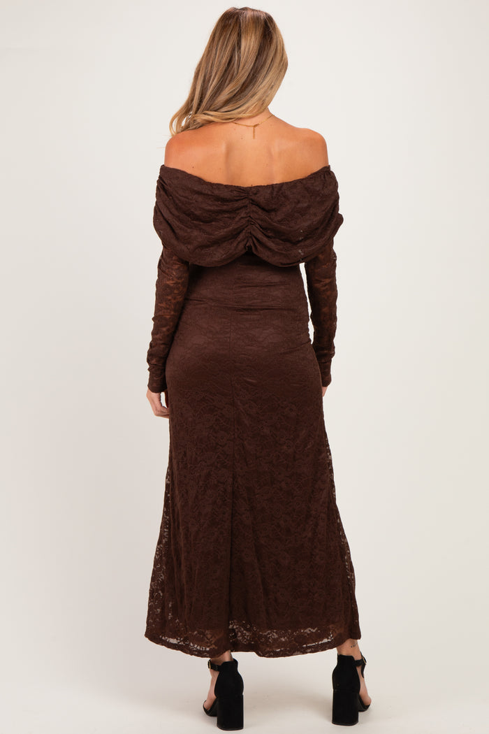 woman wearing a brown off-the-shoulder lace maternity dress with a flowing skirt and long sleeves