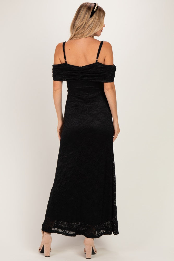 woman wearing a black off-shoulder maxi dress with lace detailing and a fitted silhouette