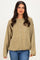 woman wearing a loose-fitting olive green cardigan with buttons and long sleeves, paired with blue jeans