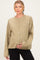 woman wearing a light olive green maternity cardigan with buttons, gently cradling her baby bump