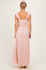 woman wearing a pastel pink lace maxi dress with ruffle straps, showing the back view