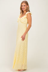 woman wearing a yellow lace maxi dress with ruffle details and a fitted silhouette