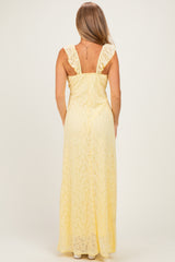 woman wearing a back view of a long yellow lace maxi dress with ruffled straps