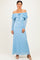 woman wearing a sky blue off-the-shoulder lace maxi dress with long sleeves and a tie detail at the neckline