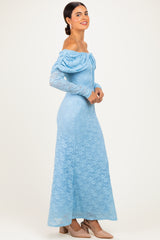 woman wearing a light blue off-the-shoulder lace gown with long sleeves and a fitted silhouette