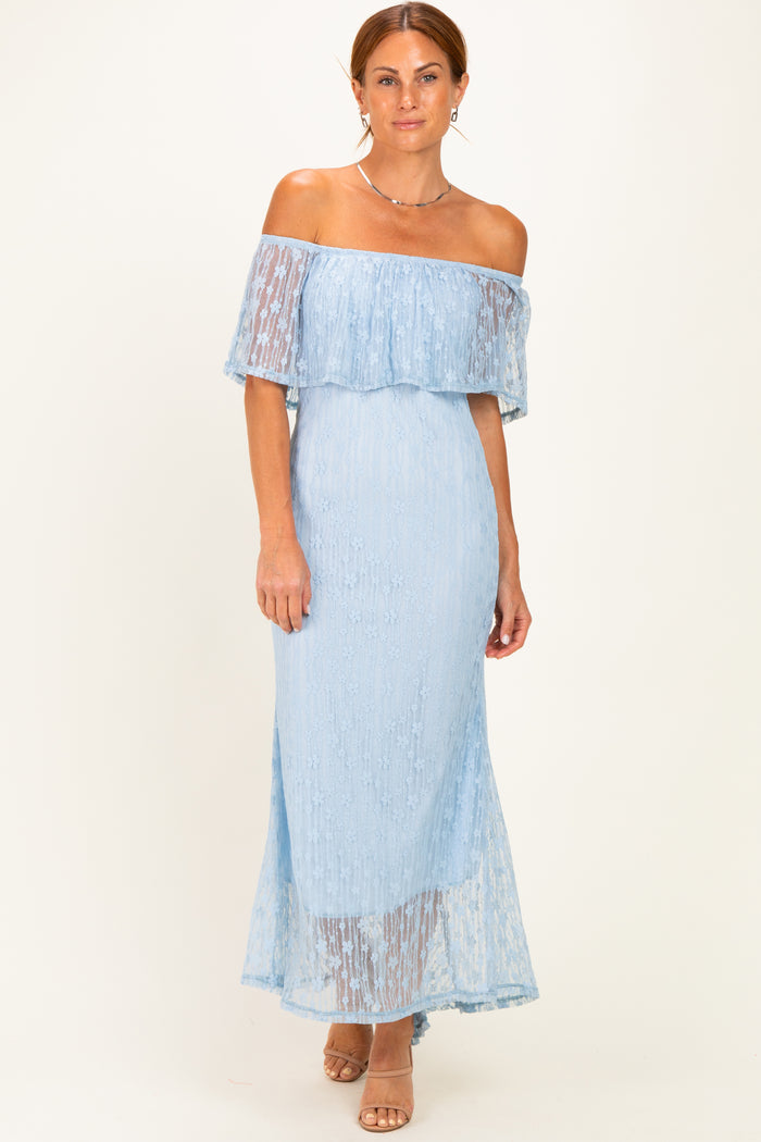 woman wearing a light blue off-the-shoulder lace maxi dress with a flowy skirt and fitted bodice