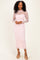 woman wearing a light pink long sleeve lace dress with floral pattern and a fitted silhouette