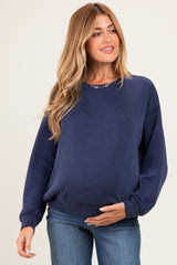 woman wearing a navy blue maternity sweatshirt with a relaxed fit and visible baby bump