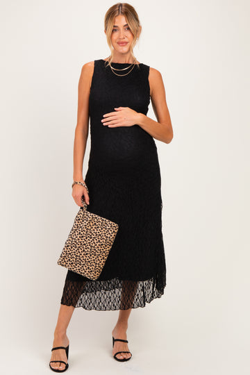 woman wearing a black lace maternity dress with a baby bump and holding a leopard print handbag