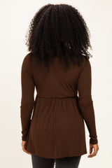 woman wearing a brown long sleeve ribbed top with a gathered waist, viewed from the back