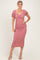 woman wearing a dusty pink fitted midi dress with puff sleeves and a ruched design