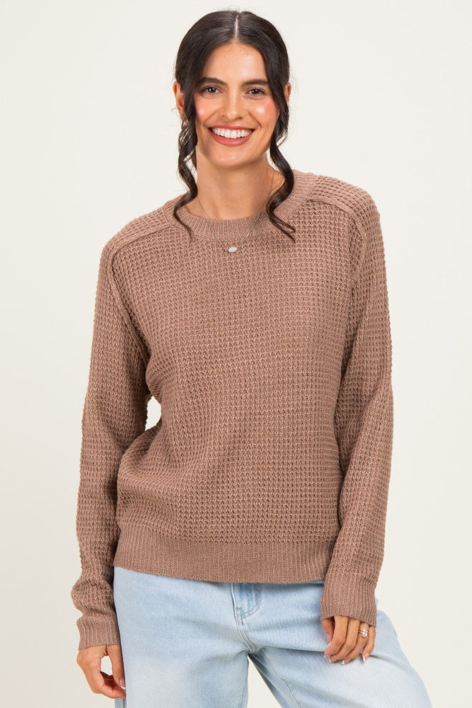 woman wearing a soft brown textured knit sweater with a relaxed fit and long sleeves