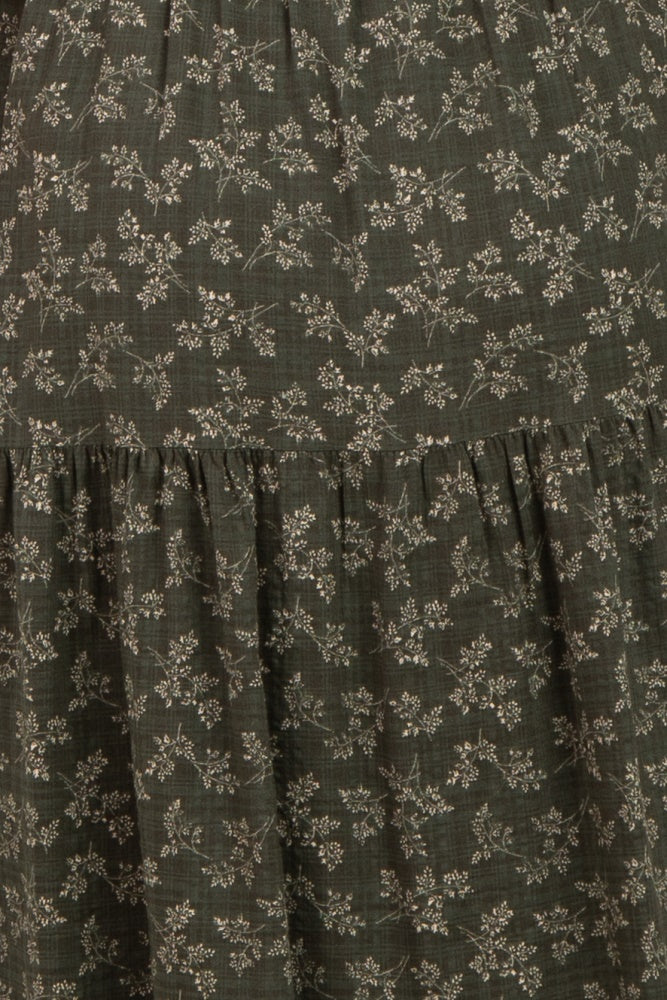 maternity wear in dark green with small floral print and tiered ruffle detailing