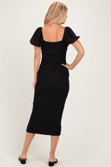 woman wearing a black fitted midi dress with puff sleeves and a square neckline, shown from the back