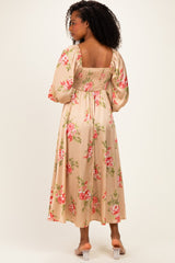 woman wearing a floral print long sleeve maxi dress with a smocked back and puff sleeves