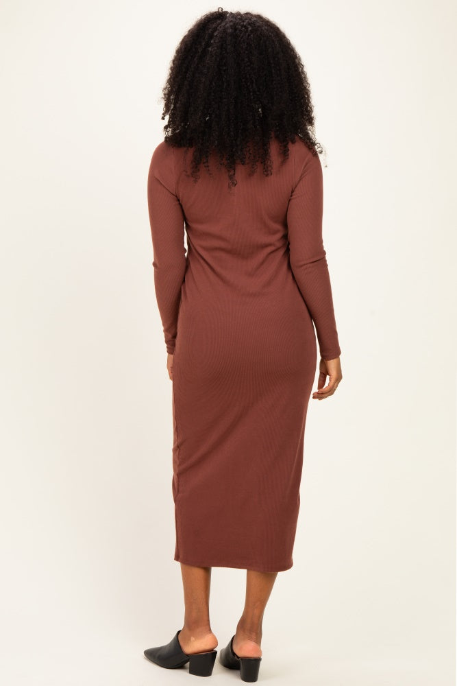 woman wearing a brown long sleeve form-fitting midi dress and black slide-on mules, showcased from the back