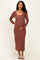 woman wearing a rust long sleeve maternity dress and holding her baby bump