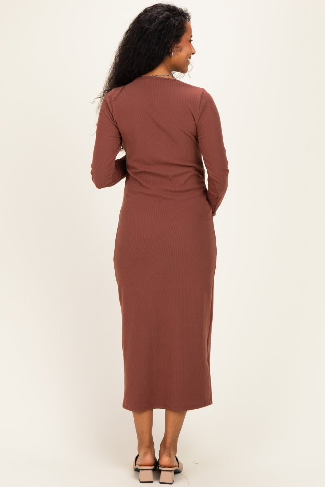woman wearing a brown ribbed long sleeve maternity dress, showing the back view
