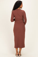woman wearing a brown ribbed long sleeve maternity dress, showing the back view