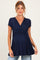 woman wearing a navy blue short sleeve maternity top with a twisted front detail and a visible baby bump