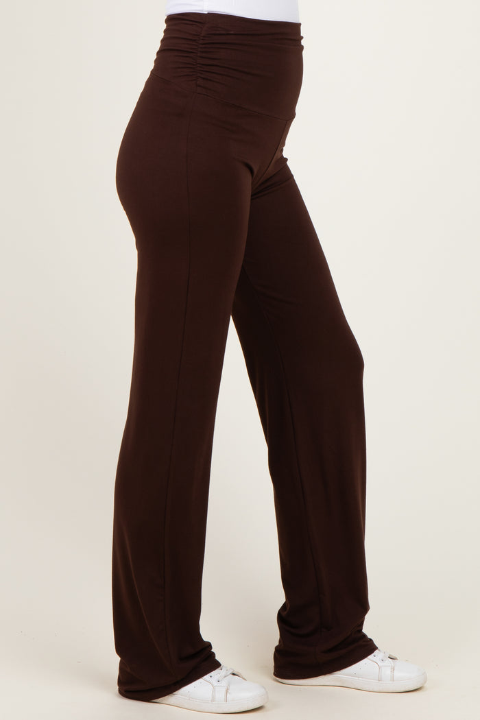 woman wearing brown stretchy pants with a high waistband and gathered side details