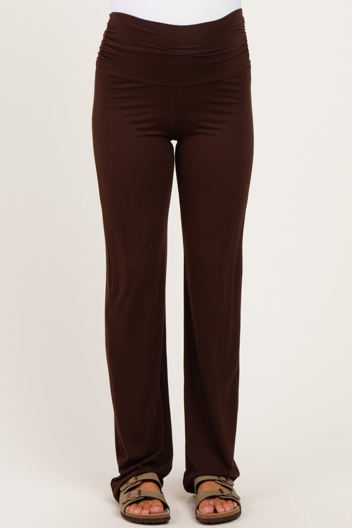 woman wearing dark brown maternity pants with a flattering ruched waistband and relaxed fit