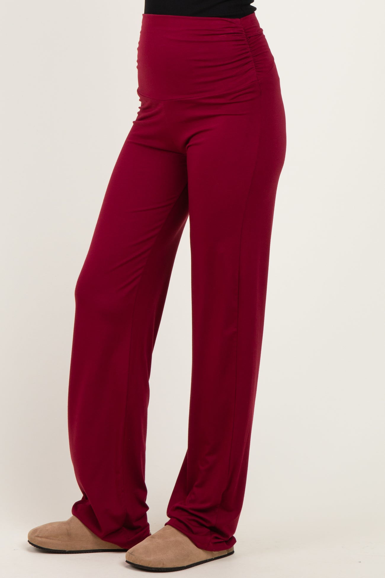 woman wearing burgundy wide-leg pants with ruching details at the waistband