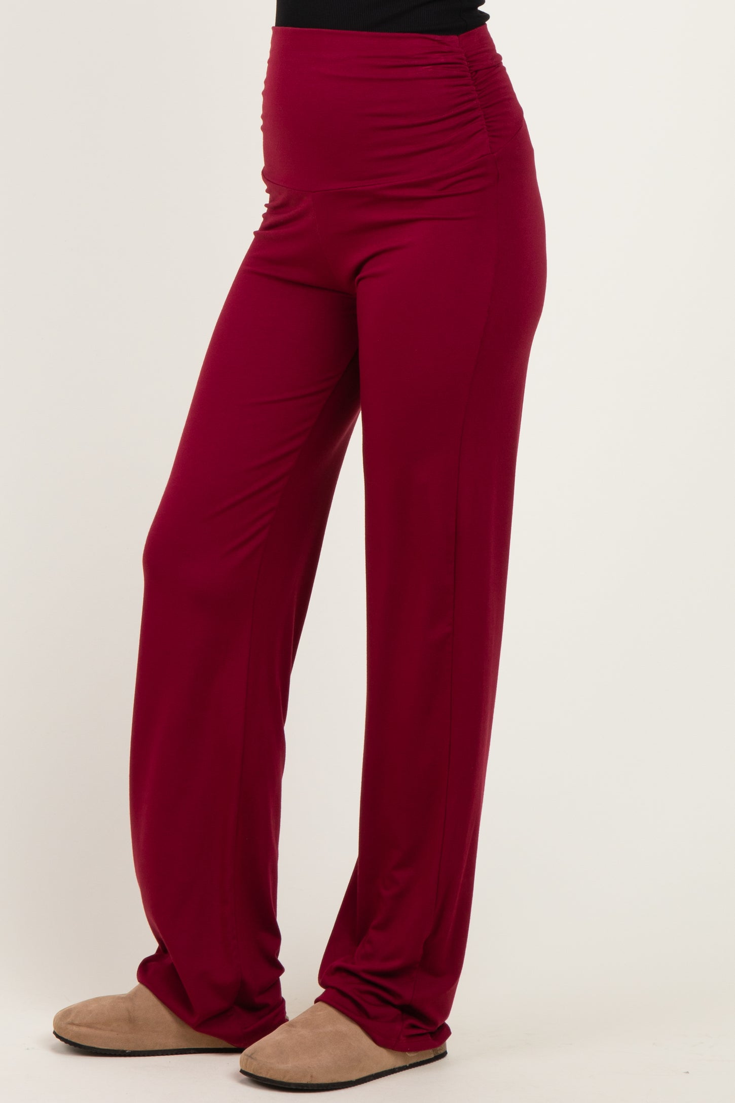 woman wearing burgundy wide-leg pants with ruching details at the waistband
