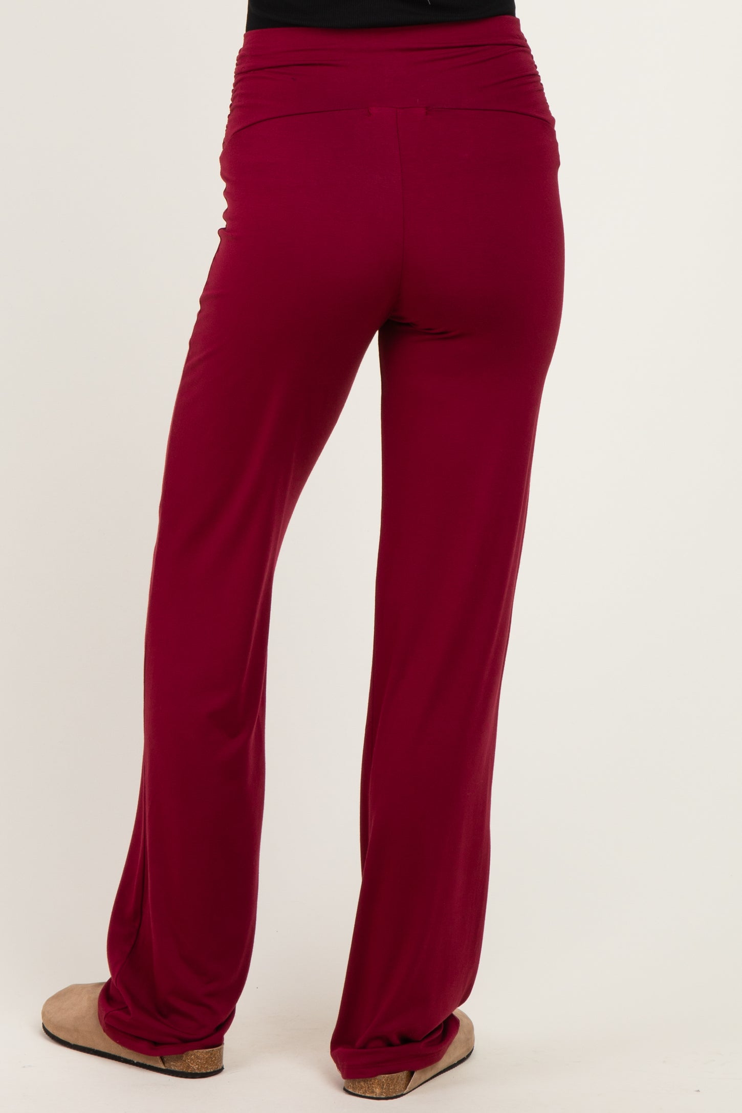 woman wearing maroon wide-leg pants viewed from the back