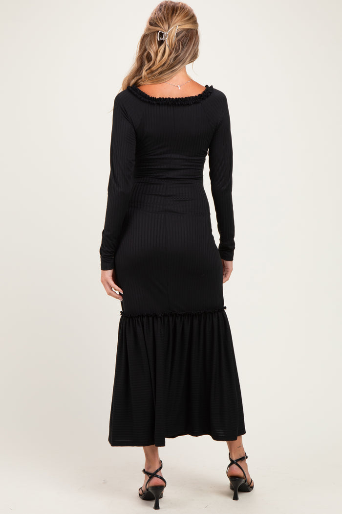 woman wearing a black ribbed maternity maxi dress with long sleeves and a ruffled hem, showing her back