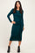 woman wearing a teal long sleeve midi dress with a side knot detail and black ankle boots