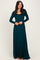 woman wearing a teal long sleeve maxi dress with a fitted bodice and flowy skirt