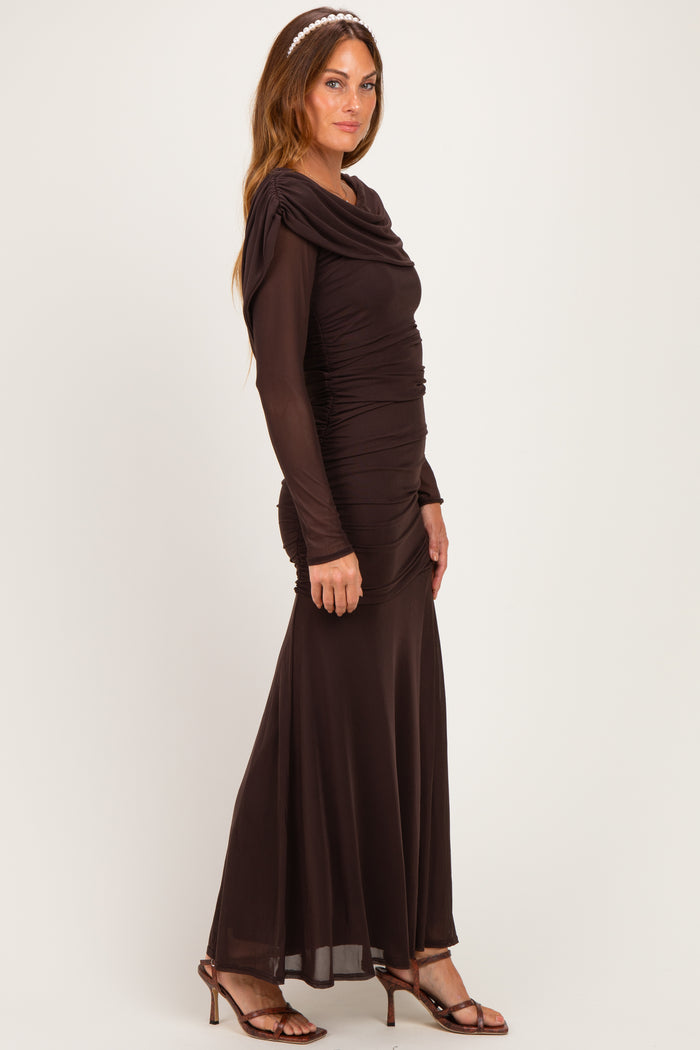 woman wearing a brown long sleeve evening gown with ruched detailing and a flowy skirt, styled with a headband