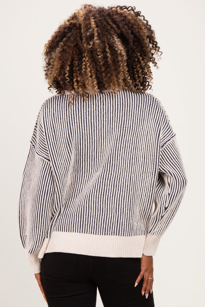 woman wearing a striped maternity sweater with wide sleeves and a relaxed fit, seen from the back