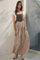woman wearing a brown striped maxi dress with a fitted bodice and flowy skirt, styled with a white t-shirt underneath