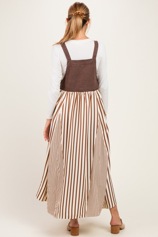 woman wearing a brown and white striped maternity dress with a fitted bodice and flowy skirt, showing her back