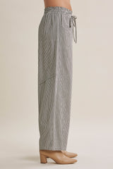 woman wearing black and white striped wide-leg pants with an elastic drawstring waist
