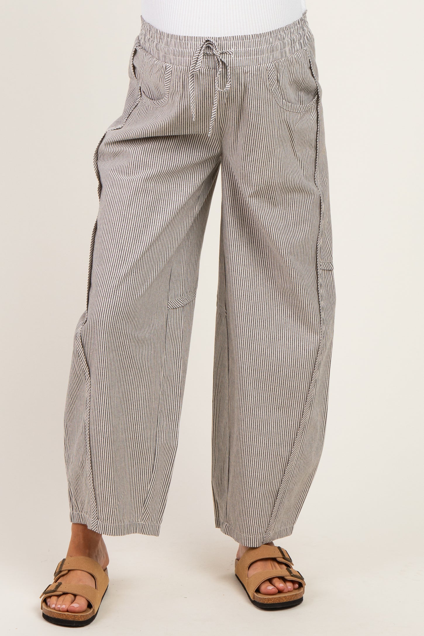 woman wearing maternity striped wide-leg pants with an elastic waistband and drawstring detail