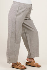 woman wearing maternity wide-leg striped pants with an elastic waistband and pockets
