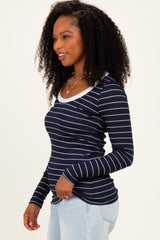 woman wearing a navy blue and white striped long sleeve top with a scoop neckline and form-fitting style