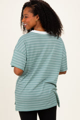 woman wearing a mint green striped oversized t-shirt with short sleeves and a side slit detail
