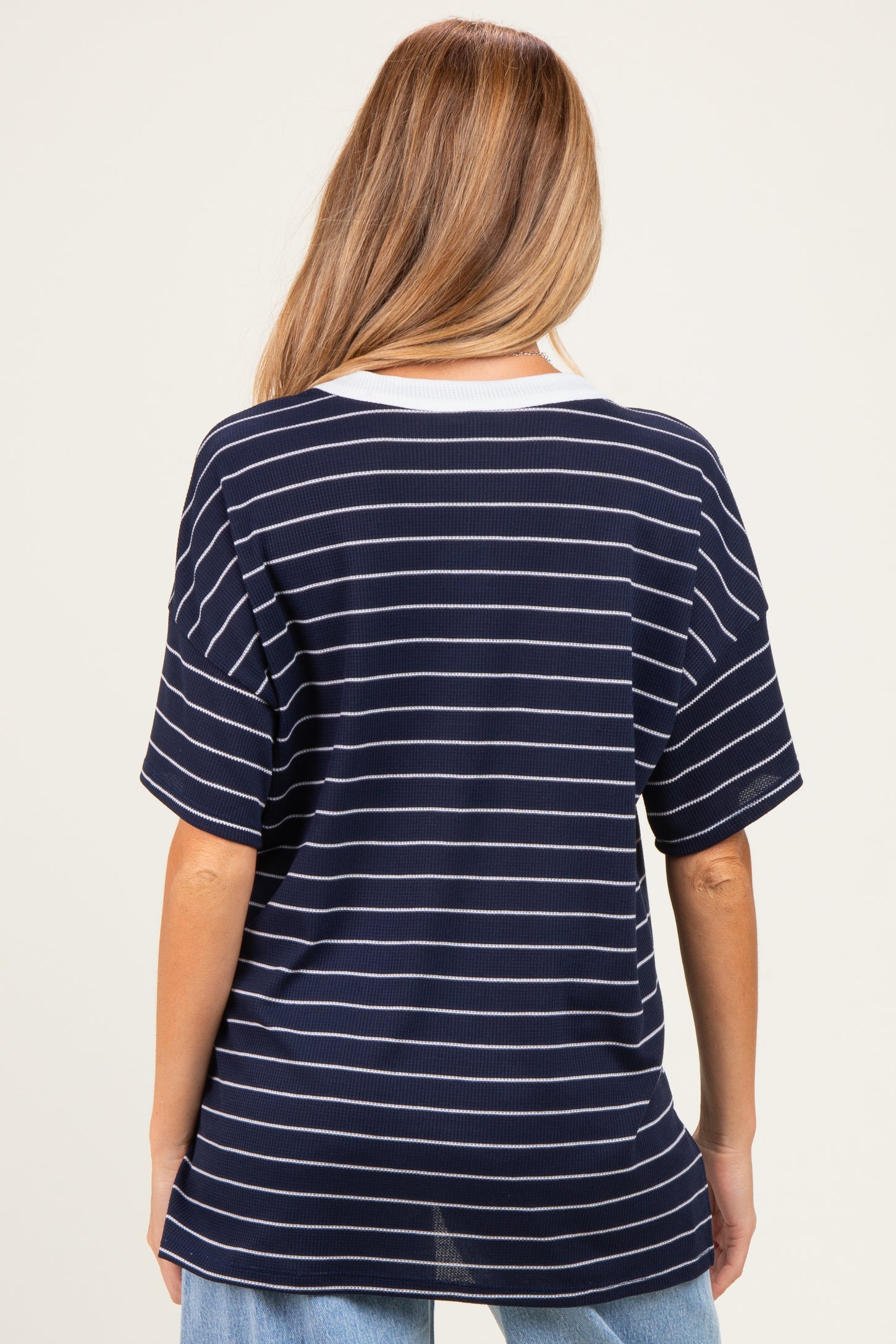 maternity wear in navy and white striped tee with a relaxed fit, model showing the back view