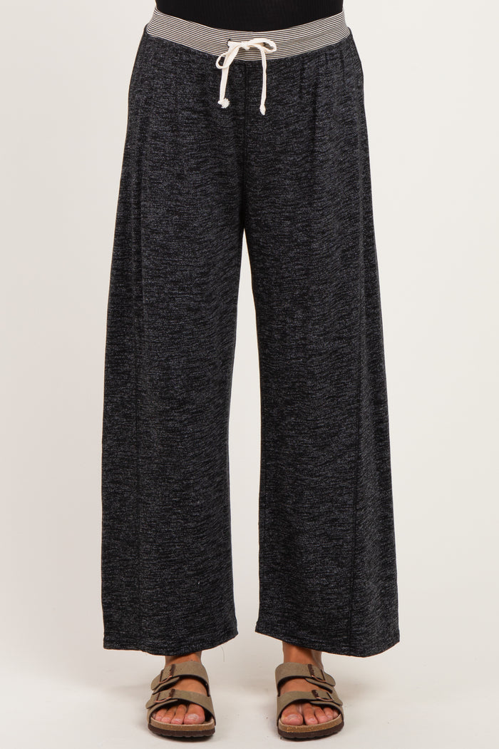 woman wearing comfortable black wide-leg maternity pants with a grey drawstring waistband