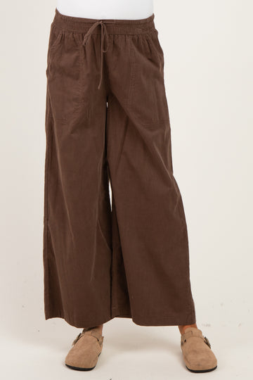 woman wearing brown wide-leg maternity pants with a drawstring waist and pockets